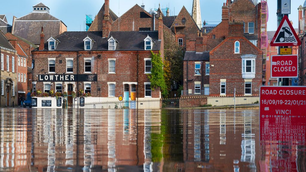 A row of flooded redbrick buildings